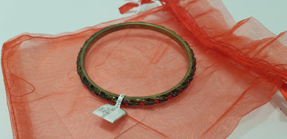 Bracelet/Bangle. Red Sparkly Gems set in a Gold Tone Bangle  BNWT